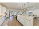 This gourmet kitchen with a large island and wine cooler opens to a patio and living room at 4607 Benito Ct, Bradenton, FL 34211