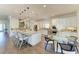 A open kitchen featuring white cabinets, stainless appliances, a large island, and an adjacent dining area at 4607 Benito Ct, Bradenton, FL 34211