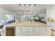 Large kitchen island with granite countertops, white cabinets, and wine storage in an open-concept space at 4607 Benito Ct, Bradenton, FL 34211