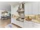Chef's kitchen showcases stainless steel appliances, granite countertops, tile backsplash, and eat-in dining space at 4607 Benito Ct, Bradenton, FL 34211