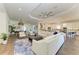 Spacious living area with neutral tones, tile flooring, and an open layout connecting to the kitchen at 4607 Benito Ct, Bradenton, FL 34211