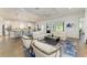Open living space featuring tile floors, neutral décor, modern furnishings, and a view of the kitchen and outdoor area at 4607 Benito Ct, Bradenton, FL 34211