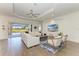 Bright living room with tile floors, modern furniture, and a view of the pool area at 4607 Benito Ct, Bradenton, FL 34211