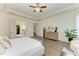 Bright main bedroom featuring a tray ceiling, wood floors, and access to the ensuite bathroom and walk-in closet at 4607 Benito Ct, Bradenton, FL 34211