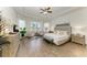 Spacious main bedroom featuring large windows, tray ceiling, sitting area, and wood-look tile flooring at 4607 Benito Ct, Bradenton, FL 34211