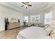 Tranquil bedroom with tray ceilings, a dresser, and a seating area by the window at 4607 Benito Ct, Bradenton, FL 34211