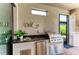 Outdoor kitchen features granite counters, built-in grill, fridge and storage plus views of the backyard at 4607 Benito Ct, Bradenton, FL 34211