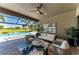 Relaxing outdoor living area with ceiling fan, comfortable seating, overlooking a pool and golf course at 4607 Benito Ct, Bradenton, FL 34211