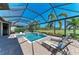 A stunning pool and hot tub with a screened-in lanai, a golf course view, plus patio seating at 4607 Benito Ct, Bradenton, FL 34211