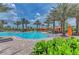 Relaxing pool with tropical foliage, lounge chairs, and cabanas with a clear sky background at 4607 Benito Ct, Bradenton, FL 34211