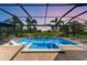 Beautiful pool and spa with golf course views at sunset in a screened enclosure at 4607 Benito Ct, Bradenton, FL 34211