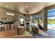 Summer kitchen featuring a grill, sink, refrigerator, and fireplace with an outdoor living area at 4607 Benito Ct, Bradenton, FL 34211