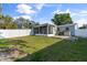 Spacious backyard with a well-maintained lawn and an enclosed porch in the background at 5001 15Th N Ave, St Petersburg, FL 33710