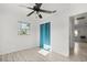 Bright bedroom featuring a window, closet with blue curtain, and wood-look flooring at 5001 15Th N Ave, St Petersburg, FL 33710