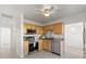 Well-lit kitchen featuring stainless appliances and light wood cabinetry at 5001 15Th N Ave, St Petersburg, FL 33710