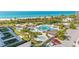 An aerial view of the community pool, beach, and landscaping showcasing the resort style living at 545 Sanctuary Dr # B806, Longboat Key, FL 34228