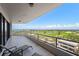 Spacious balcony with comfortable seating overlooking the golf course and waterfront at 545 Sanctuary Dr # B806, Longboat Key, FL 34228