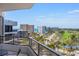 Balcony view overlooking palm trees, a golf course, and buildings with the blue ocean on the horizon under a clear blue sky at 545 Sanctuary Dr # B806, Longboat Key, FL 34228