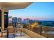 Beautiful twilight view from the balcony offering a panorama of city lights, ocean and a verdant golf course at 545 Sanctuary Dr # B806, Longboat Key, FL 34228