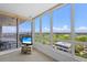 Bedroom view showcasing expansive windows, a TV, and golf course scenery at 545 Sanctuary Dr # B806, Longboat Key, FL 34228