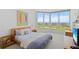 Bright bedroom with bay windows offers picturesque views of the waterfront and golf course at 545 Sanctuary Dr # B806, Longboat Key, FL 34228