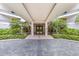 Elegant building entrance with landscaped greenery and a stone walkway at 545 Sanctuary Dr # B806, Longboat Key, FL 34228
