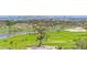Beautiful golf course with lush green fairways, mature trees, and stunning city views in the distance at 545 Sanctuary Dr # B806, Longboat Key, FL 34228