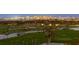 Scenic golf course view featuring lush green fairways, palm trees and a tranquil waterway with the city skyline in the background at 545 Sanctuary Dr # B806, Longboat Key, FL 34228