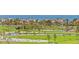 Expansive golf course view with lush green fairways, tall palm trees, and serene water features under a bright sunny sky at 545 Sanctuary Dr # B806, Longboat Key, FL 34228
