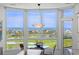 This kitchen nook has great natural light and views of a golf course and the bay from the bay window at 545 Sanctuary Dr # B806, Longboat Key, FL 34228