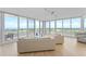 Bright open living area with balcony access, showcasing the beautiful view and comfortable seating arrangements at 545 Sanctuary Dr # B806, Longboat Key, FL 34228