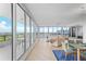 Bright living room boasts floor-to-ceiling windows with beautiful city and golf course views, plus modern decor at 545 Sanctuary Dr # B806, Longboat Key, FL 34228