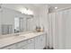 Bright bathroom with double sinks, quartz countertops, and a large mirror at 5664 Palmer Cir # 102, Bradenton, FL 34211