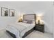 Comfortable bedroom with neutral tones, an accent wall, and stylish bedside lamps at 5664 Palmer Cir # 102, Bradenton, FL 34211