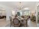Bright dining area featuring a round table, chandelier, and large windows at 5664 Palmer Cir # 102, Bradenton, FL 34211