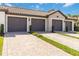Villa garages with pavers and driveway, showing a well-maintained exterior and landscaping at 5664 Palmer Cir # 102, Bradenton, FL 34211