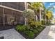 Beautiful landscaped condo exterior with lush greenery and inviting entryway, showcasing the community's curb appeal at 5664 Palmer Cir # 102, Bradenton, FL 34211