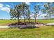 Picturesque golf course and community lake with mature landscaping and clear blue skies at 5664 Palmer Cir # 102, Bradenton, FL 34211