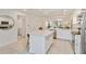 Bright kitchen features white cabinets, stainless appliances, and a large island perfect for entertaining at 5664 Palmer Cir # 102, Bradenton, FL 34211