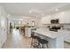 Bright, modern kitchen featuring stainless steel appliances, quartz countertops, and a breakfast bar at 5664 Palmer Cir # 102, Bradenton, FL 34211