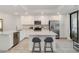 Modern kitchen featuring stainless steel appliances, white cabinets, and a quartz countertop island at 5664 Palmer Cir # 102, Bradenton, FL 34211
