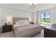 Serene main bedroom with a large window offering picturesque views of the golf course at 5664 Palmer Cir # 102, Bradenton, FL 34211