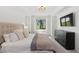 Bright bedroom with a king bed, golf course view, and a modern dresser at 5664 Palmer Cir # 102, Bradenton, FL 34211