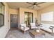 Charming covered patio features comfortable seating and a ceiling fan for outdoor relaxation at 5664 Palmer Cir # 102, Bradenton, FL 34211