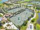 Aerial view of multiple tennis courts and lush landscaping in the community at 5664 Palmer Cir # 102, Bradenton, FL 34211