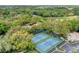 Aerial view of the community tennis courts, showcasing lush landscaping and a convenient parking area at 5711 Garden Lakes Palm, Bradenton, FL 34203