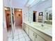 Well-lit bathroom with a double sink vanity and a large mirror at 5711 Garden Lakes Palm, Bradenton, FL 34203