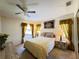 Comfortable bedroom with a ceiling fan, windows, and stylish furnishings at 5711 Garden Lakes Palm, Bradenton, FL 34203
