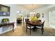 Bright dining room with table set for dinner, stylish mirror decor, and neutral walls at 5711 Garden Lakes Palm, Bradenton, FL 34203