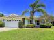 Charming single-story home with manicured lawn, mature landscaping, and a spacious two-car garage at 5711 Garden Lakes Palm, Bradenton, FL 34203